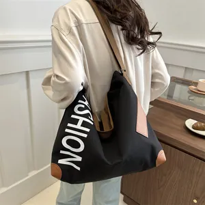 Minimalist black canvas tote bag with fashion print and brown straps for daily commute