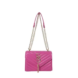 Fuchsia quilted crossbody bag with golden SSS logo and fringe on a white background