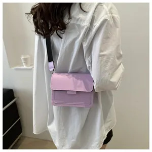 Lilac crossbody bag with wide strap shown on model to display size and fit