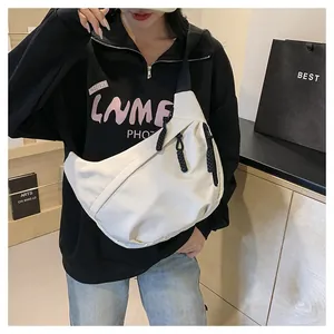 Detail of white nylon crescent bag with black zippers and woven cord pulls for women