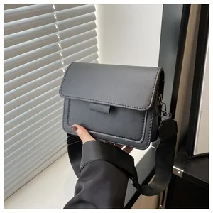 Close-up of charcoal grey PU leather bag showing stitching and wide nylon strap