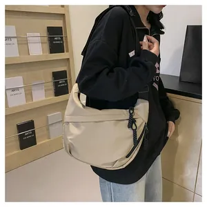 Close-up of beige waterproof nylon tote bag with black zipper and woven puller detail