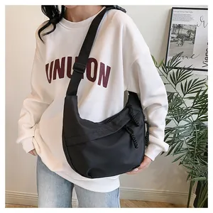 Detailed view of black nylon crescent bag with adjustable wide strap for daily commute