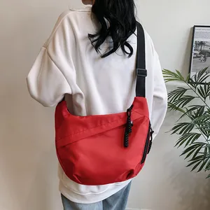 Fashionable red crescent tote bag with adjustable wide shoulder strap in street style