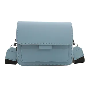 Minimalist light blue PU leather crossbody bag with wide black strap and silver buckles
