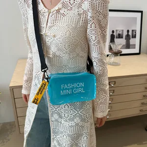 Blue transparent PVC mini crossbody bag with Fashion Mini Girl text and woven strap