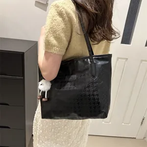 Large capacity black tote bag with houndstooth texture and white plush charm detail