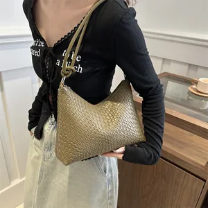 Olive green woven leather tote bag with knotted shoulder strap for elegant women