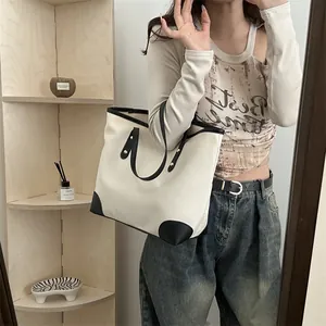 Bolso tote grande minimalista en lona beige con ribetes negros en contraste para mujer