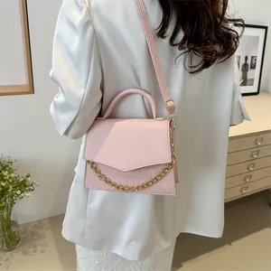Pink croc-effect crossbody bag for women with gold chain handle and adjustable strap