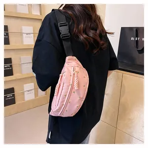 Detailed back view of a pink floral nylon crossbody bag with adjustable strap