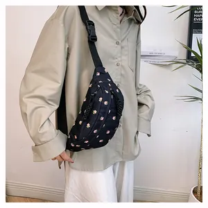 Close-up of black floral waist bag featuring adjustable strap and buckle closure