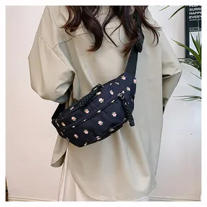 Detail of floral fanny pack with pink tulip pattern and braided rope zipper pulls