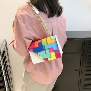 Chic crossbody bag with colorful geometric patchwork pattern and golden chain strap