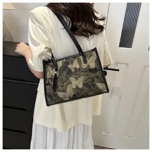 Detail of butterfly jacquard fabric and black leather tassel on a stylish tote bag