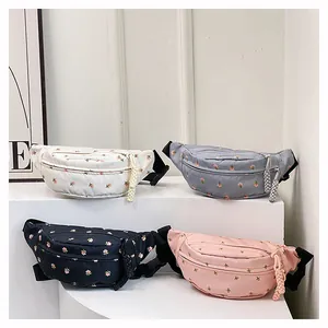 Variety of floral waist bags in different colors displayed on modern white pedestals
