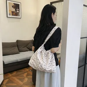 Minimalist floral drawstring shoulder bag for women with fresh pink pattern and wide strap