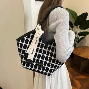 Chic black and white checkered tweed tote bag for women with a decorative lettered ribbon