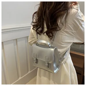 Chic silver metallic mini backpack for women featuring double buckle design and top handle