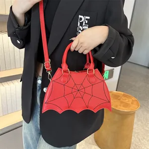 Gothic red bat-shaped handbag with black spider web embroidery and golden hardware detail