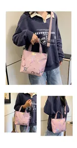 Detail of pink nylon tote bag featuring colorful splatter paint and laser printed letters