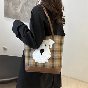 Brown plaid tote bag with cute schnauzer embroidery shown from a side back view
