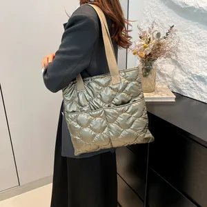 Minimalist quilted tote bag in metallic sage green with wide strap for women