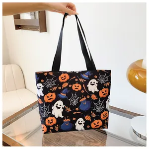Detail of Halloween printed tote bag with pumpkin, ghost and web patterns on black canvas