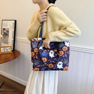Halloween purple tote bag with pumpkin and ghost prints worn on shoulder by a model