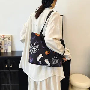 Halloween tote bag with ghost and pumpkin prints on black canvas for autumn fashion