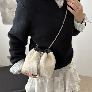 Fuzzy cream bucket bag with silver chain and pearl drawstring for fall fashion