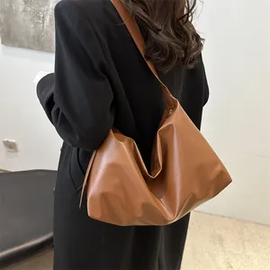 Chic caramel brown faux leather oversized hobo shoulder bag for casual autumn styling
