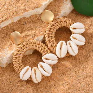 Handmade raffia hoop earrings with natural cowrie shells for bohemian beach vacations