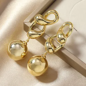 Minimalist gold link drop earrings with polished metal sphere on elegant satin background