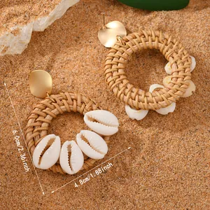 Detailed view of bohemian woven rattan earrings with shell charms and size dimensions