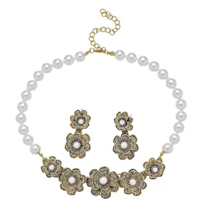 Detailed shot of retro gold flower jewelry set featuring pearl necklace and earrings