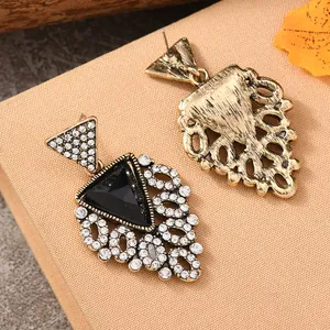 Macro shot of bohemian fan-shaped earrings with rhinestones and antique gold finish