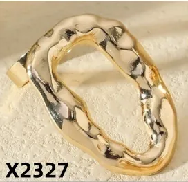 Detail shot of gold-plated irregular oval ring with unique hammered texture surface