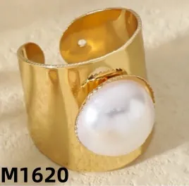 Macro detail of bohemian gold-plated open ring featuring a large white faux pearl