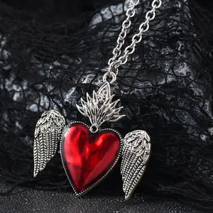 Gothic vintage silver winged necklace with a vibrant red heart pendant and O-chain