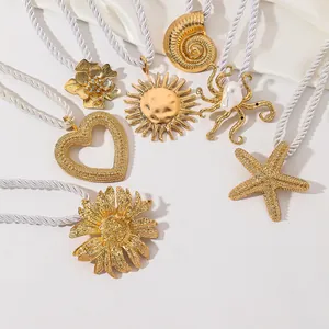 Detailed view of sun-shaped golden metal curtain tieback with white braided rope