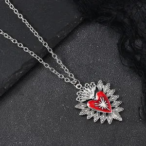 Macro shot of Gothic red enamel heart pendant with silver starburst carving detail