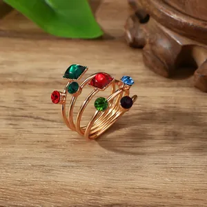 Detail of multi-layer spiral scarf ring with colorful gemstones on a wooden background