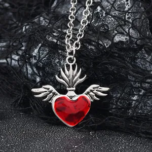 Detailed view of Gothic winged red heart pendant with vintage silver finish and chain