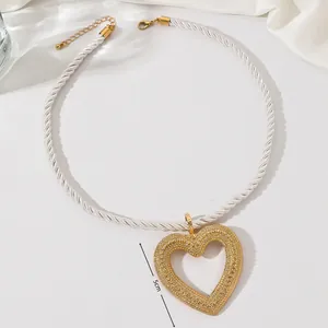 Minimalist white rope necklace with a large gold textured hollow heart pendant, 5cm size