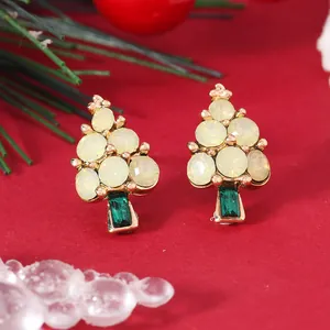 Detail of Christmas tree stud earrings with gold plating and colorful gemstones