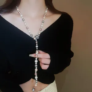 Detail of Y-shaped necklace with multi-color pearls and camellia flower pendant