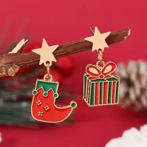 Detail of Christmas stocking and gift box charms on star-shaped stud earrings