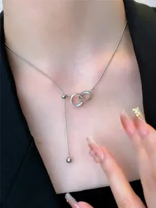 Interlocking silver double rings necklace worn on neck with elegant tassel design