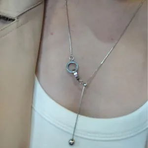 Silver Y-shaped tassel necklace with minimalist circle pendant and bead drop design